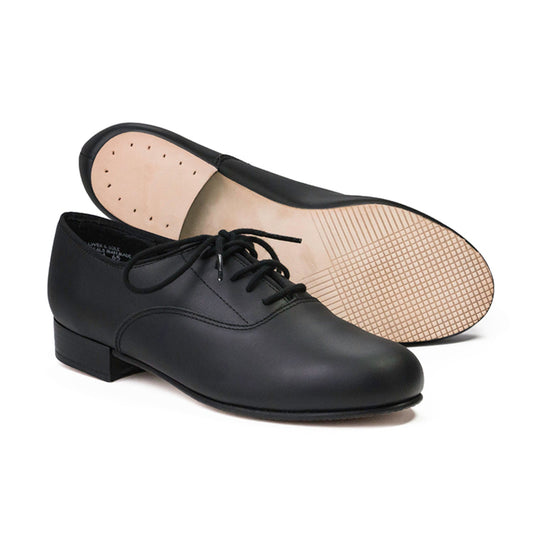 Shim Sham Oxford men’s character shoe in black leather, lace-up oxford styling, cushioned suede sock liner, leather sole with leather heel lift—modeled in performance pose