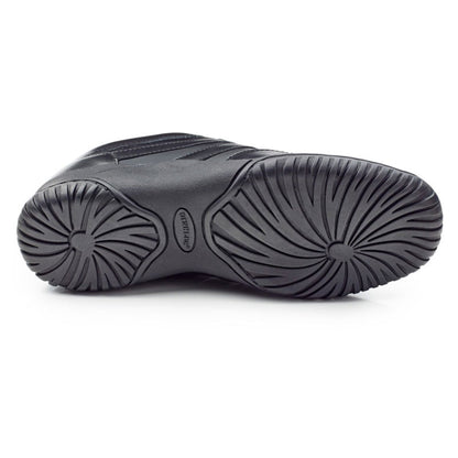 Sole view of Dinkles Spin showing smooth rubber split‑sole with pivot circle and segmented flex grooves for fluid spins and high-impact performance.